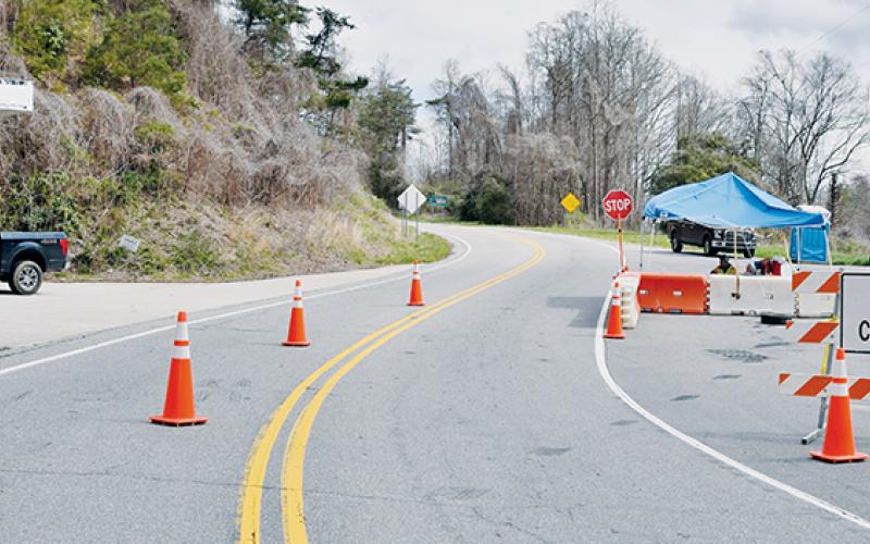 In this March 29 photo, Graham County Deputy Jim Hyde (left) and Graham County Land’s Quinn Carver help man one of the five entry points into the county, which were closed to non-residents in the wake of the COVID-19 outbreak. Photo by Art Miller/amiller@grahamstar.com