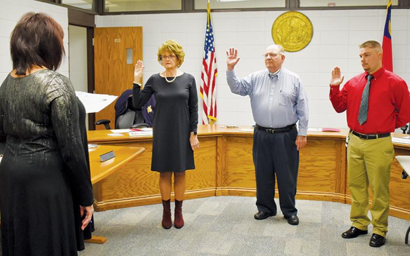 Graham County Clerk of Court Tammy Holloway swears in (from left) newly-elected Board of Education member Pam Knott, incumbent chairman Rodney Nelson and new member Jonathan Allison. Photo by Charlie Benton/news@grahamstar.com