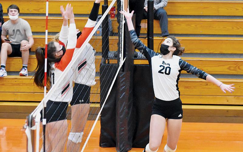 Yeika Jimenez launches for a hit past a pair of Rosman defenders during Tuesday’s road conference match. Photos by Kevin Hensley/editor@grahamstar.com