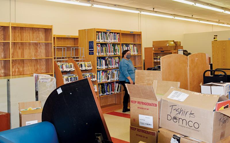 Re-assembling the library is just one of several things Snowbird is doing during its temporary stint in the Ingles Shopping Center. Photos by Art Miller/amiller@grahamstar.com