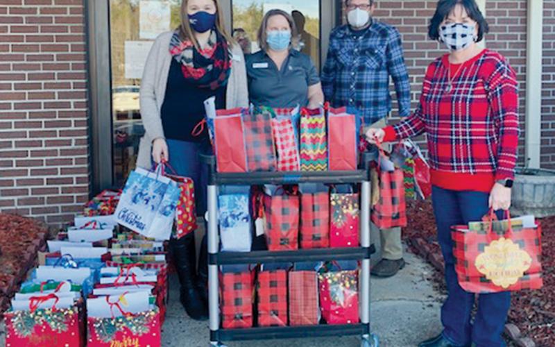 United Community Bank representatives Adara Crisp and Monica Farley (back left, center) teamed up with Graham Healthcare &amp; Rehabilitation’s Tim Adams to spread Christmas joy to residents at the long-term care facility. Standing in front is bank manager Pam Shaffer.