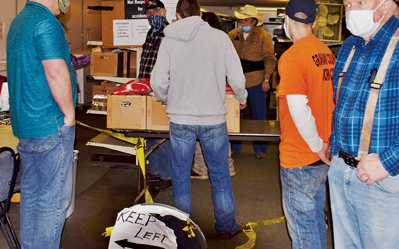 Workers assemble supplies during the final Graham Emergency Food Bank distribution on Dec. 30. Photo by Art Miller/amiller@grahamstar.com