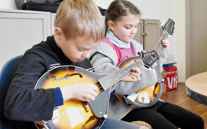 Joshua Kamps (left) and Calista Holder – both 9 – refine their mandolin craft as part of the Stecoah Valley Cultural Arts Center’s Junior Appalachian Musicians (JAM) program on Feb. 17. Photos by Charlie Benton/news@grahamstar.com