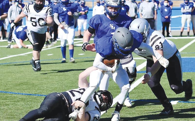 Robbinsville seniors Lex Hooper (20) and Rossi Wachacha (81) combine forces to bring down a Smoky Mountain runner during Saturday’s scrimmage.