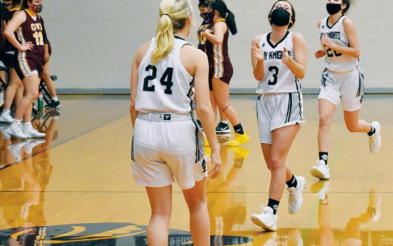 Though exhausted, Robbinsville’s Gabby Hooper (3) begins to applaud the Lady Knights’ effort after a 77-70, triple-overtime triumph over Cherokee Lady Braves. Greeting Hooper is Kensley Phillips; Yeika Jimenez (20) is not far behind beginning the celebration. Photos by Kevin Hensley/editor@grahamstar.com