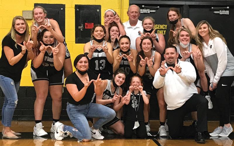 Robbinsville Lady Knight players and staff gather to celebrate the program's first Smoky Mountain Conference title since 2010, clinched tonight with a 67-50 win at Murphy. Photo by Kevin Hensley/editor@grahamstar.com