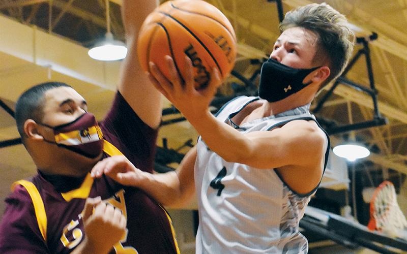 Sophomore point guard Brock Adams soars past Cherokee’s Tariq Underwood during Feb. 9’s home match-up with the Braves. Adams was one of four Robbinsville boys named to the All-Conference team. Photo by Kevin Hensley/editor@grahamstar.com