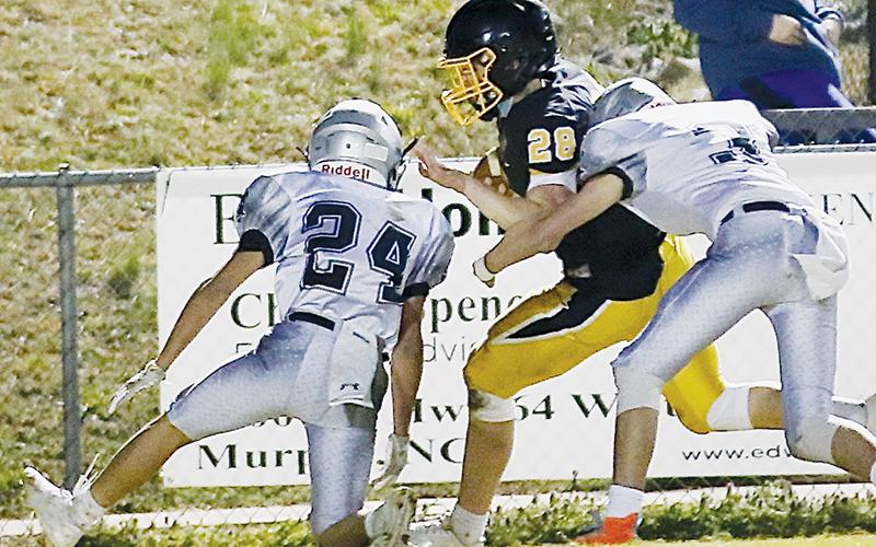 Junior varsity Black Knights Alexis Panama (24) and Christian Phillips (3) combine forces to take down Murphy’s Hunter Stalcup during March 4’s road game. Photo by Miranda Buchanan/Robbinsville High School Yearbook