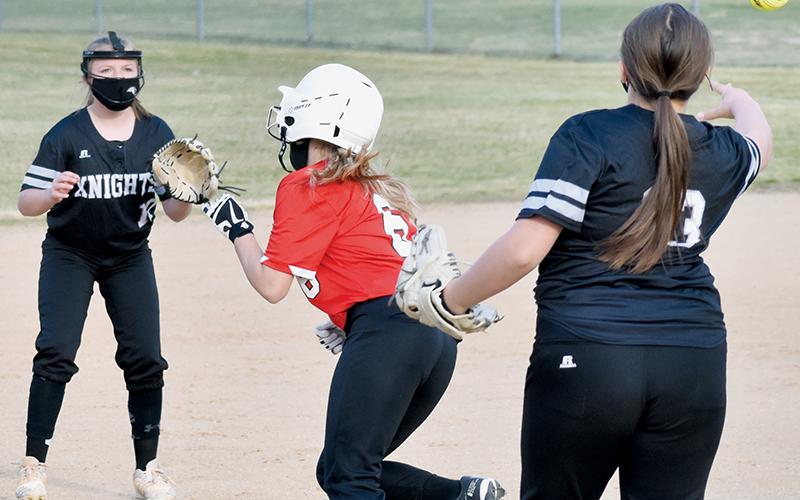 Robbinsville Middle School’s Dreylee Webster (13) and Sydney Adams have Andrews’ Alaina Flowers caught in a rundown during Tuesday’s road opener against the Lady Wildcats. Adams would tag out Flowers to complete a 2-4-6-5-4 fielder’s choice moments later. Photo by Kevin Hensley/editor@grahamstar.com