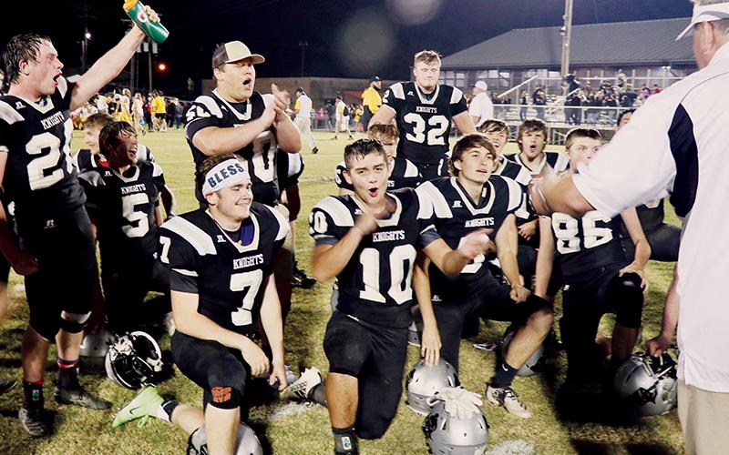 Black Knights head coach Dee Walsh (right) greets his team to celebrate clinching the Smoky Mountain Conference championship after defeating Murphy 17-7 on Friday. Photos by Miranda Buchanan/Robbinsville High School Yearbook