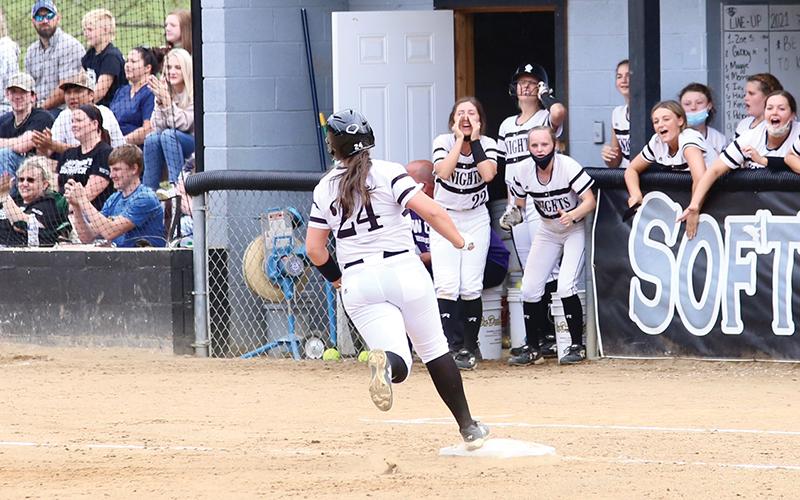 With her teammates celebrating in the dugout, Ivy Odom turns the third-base bag after hitting a 2-run homer during Tuesday’s 11-6 victory over Murphy. The win put Robbinsville in a first-place tie atop the Smoky Mountain Conference standings. Photo by Miranda Buchanan/Robbinsville High School Yearbook