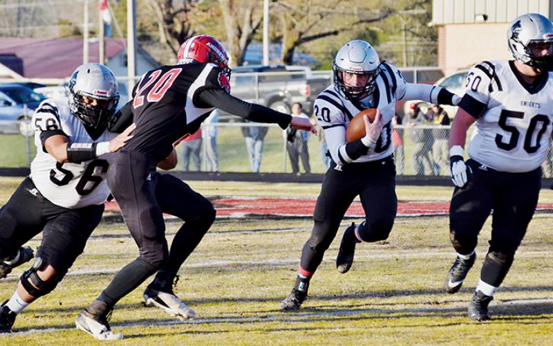 Carlos Wesley (56) and Candler Edwards (50) make sure that Lex Hooper has room to run during an April 2 game in Andrews. The trio were three of 15 Robbinsville players recently named All-Smoky Mountain Conference. Photo by Art Miller/amiller@grahamstar.com