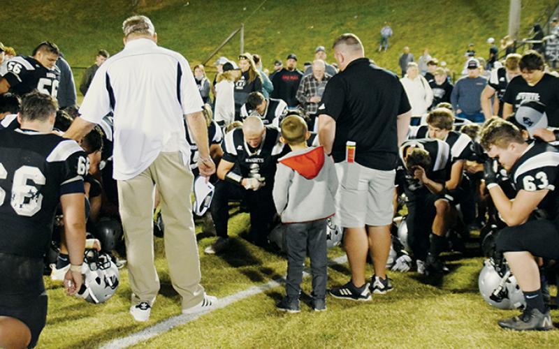 Members of the Robbinsville football program share the final post-game prayer of the 2020-21 season moments after falling 24-14 to Murphy in the Western Regional championship game. The loss ended the Black Knights’ defense of the state 1A championship. Photos by Art Miller/amiller@grahamstar.com