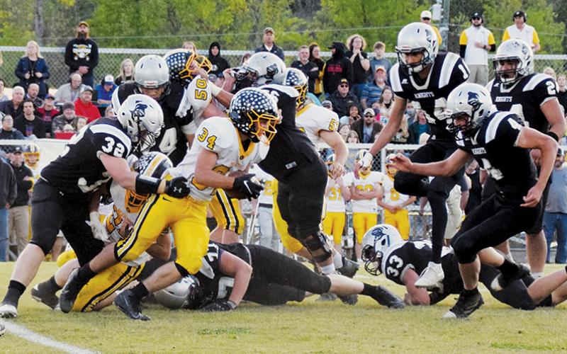 Ty Harrell (32) and Cuttler Adams (4) close in on Murphy’s Ty Laney during Friday’s 1A Western Regional title game.