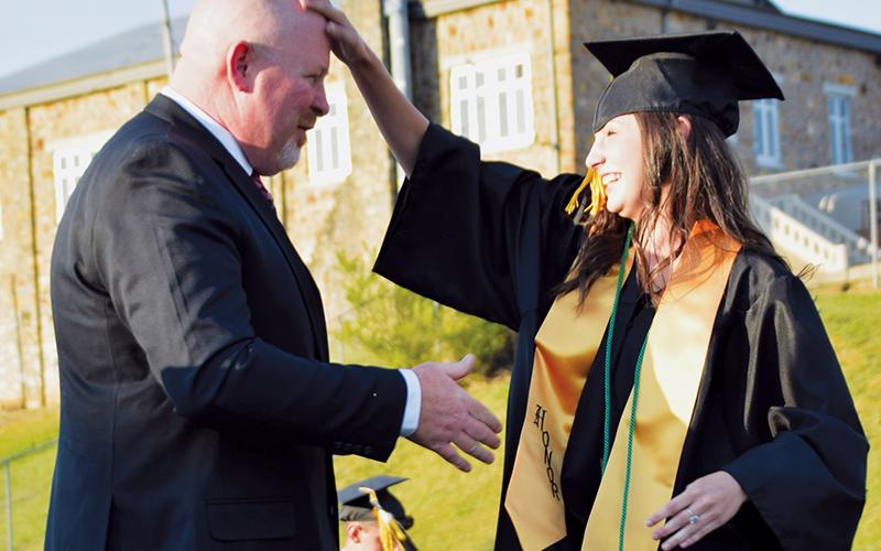 Robbinsville High School principal David Matheson was prepared to shake hands, but Emma Wiggins had other plans.