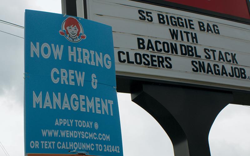 A sign at the Robbinsville Wendy’s restaurant advertises help wanted, as Graham County continues to have the highest unemployment numbers in the Southwestern region. Photo by Charlie Benton/news@grahamstar.com