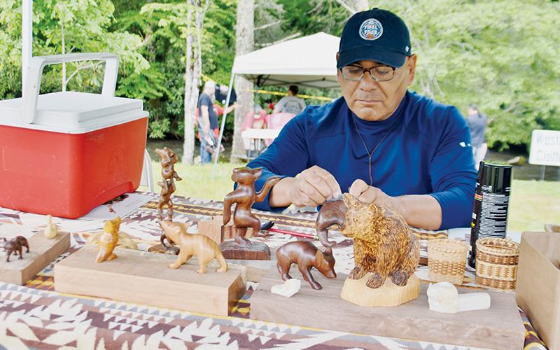 Charles Watty works on wood carving at  Saturday’s demonstration.