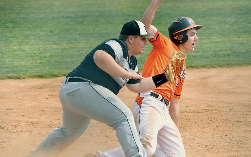 Despite the pleas of Rosman’s Andrew Stamey, Robbinsville’s Hunter Jones swipes up after applying the tag on a 2-5 caught stealing Tuesday, which ended the bottom of the first. The Knights went on to drop the game to the Tigers, 6-1. Photo by Kevin Hensley/sports@grahamstar.com