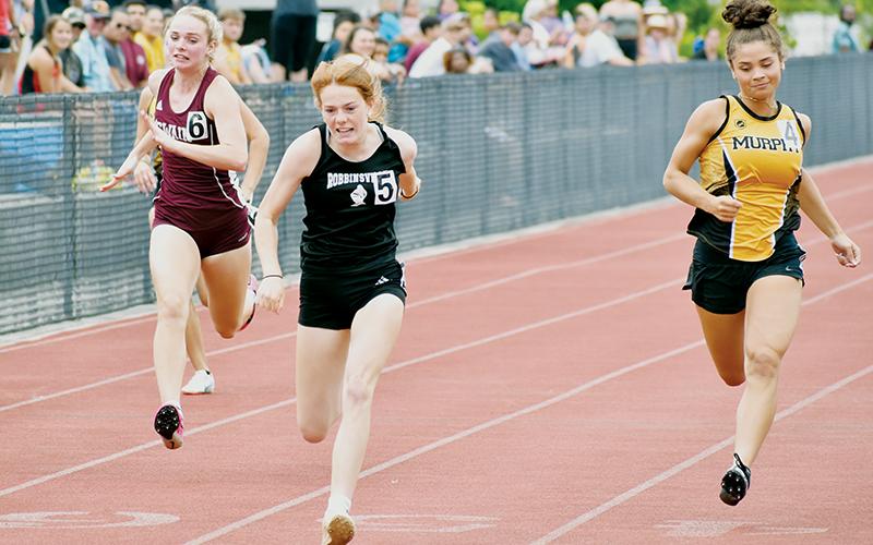 Zoie Shuler (center) beats out Murphy’s Grace Nelson (right) and Swain County’s Mazie Helpman (left) to win the 100-meter dash at the June 9 Smoky Mountain Conference championship meet at Cherokee.