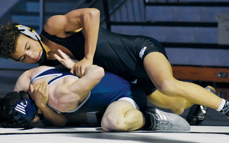 Robbinsville’s Jayden Nowell cinches in a hammerlock on Enka’s Damien Maxwell during a 132-pound bout May 15. The Knights will host the Smoky Mountain Conference tournament next week. Photo by Kevin Hensley/sports@grahamstar.com