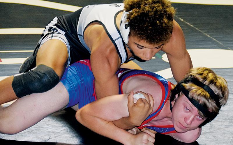 Jayden Nowell maintains top control over West Henderson’s Cody Eplee during Saturday’s home dual with the Falcons. Nowell would go on to cinch career win No. 101 in the bout. Photos by Art Miller/amiller@grahamstar.com
