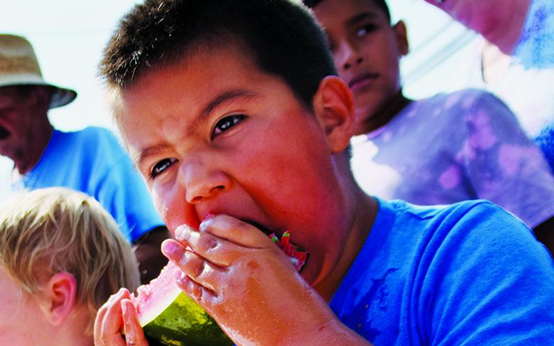 Six-year-old contestant Ryder Fortenberry worked hard to finish the watermelon-eating contest, held as part of the Graham County Heritage Festival on Saturday. Photos by Art Miller/amiller@grahamstar.com