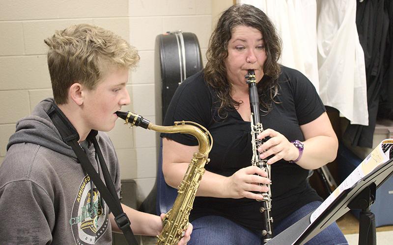 New Graham County Schools music educator Amber Watkins (right) works one-on-one with freshman tenor saxophonist Ryan Lynn Monday. The band is currently preparing its marching show for the upcoming season. Photo by Charlie Benton/news@grahamstar.com