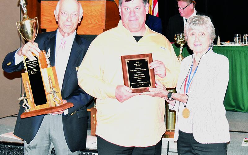 Robbinsville’s Nathan Collins was named the Keller Ferrell Division II Male Athlete – Major Sport Award winner at Sunday’s Mountain Amateur Athletic Club WNC Sports Awards Banquet in Asheville. Receiving the award on Nathan’s behalf was his father, Michael. With Michael is Mountain Amateur Athletic Club Board of Directors members David Cappiello (left) and Ann Brandis. Photos by Kevin Hensley/sports@grahamstar.com