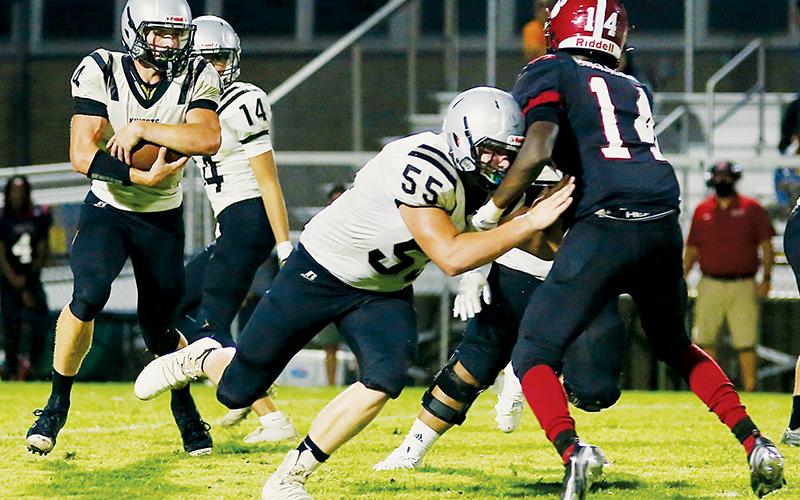 Sophomore tackle Koleson Dooley (55) runs interference for classmate Cuttler Adams (4) during Friday’s season opener against the Asheville Cougars. Along with another sophomore – Kage Williams – Adams had three touchdowns in Robbinsvile’s 45-23 victory. Photo by Miranda Buchanan/Robbinsville High School Yearbook