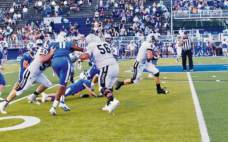 Cuttler Adams (4) breaks through the pack during Friday’s game at Brevard. Adams scored both of Robbinsville’s touchdowns in a 16-15 loss to the Blue Devils. Photo by Miranda Buchanan/Robbinsville High School Yearbook