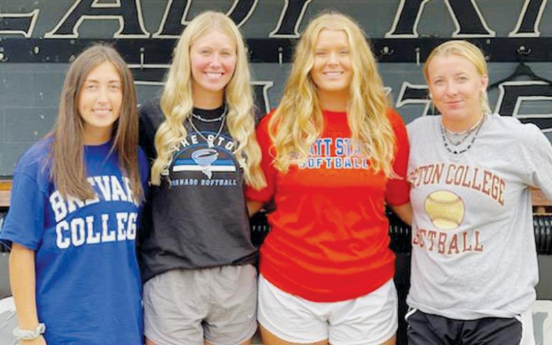 Lady Knights softball alumni Gabby Hooper, Mikayla Morgan, Maggie Knight and Abigail Knight (from left) have each continued their careers at the collegiate level.