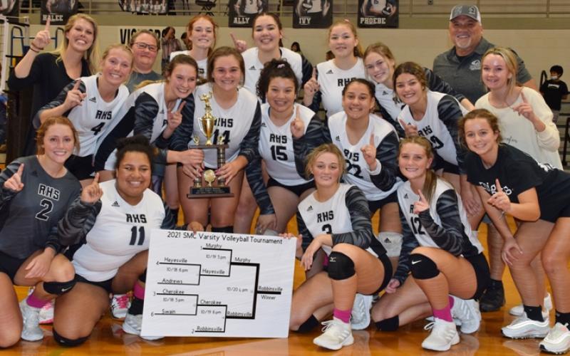 The Robbinsville Lady Knights gather in celebration, moments after defeating Murphy in four sets Wednesday night to win the 2021 Smoky Mountain Conference tournament. Photo by Art Miller/amiller@grahamstar.com