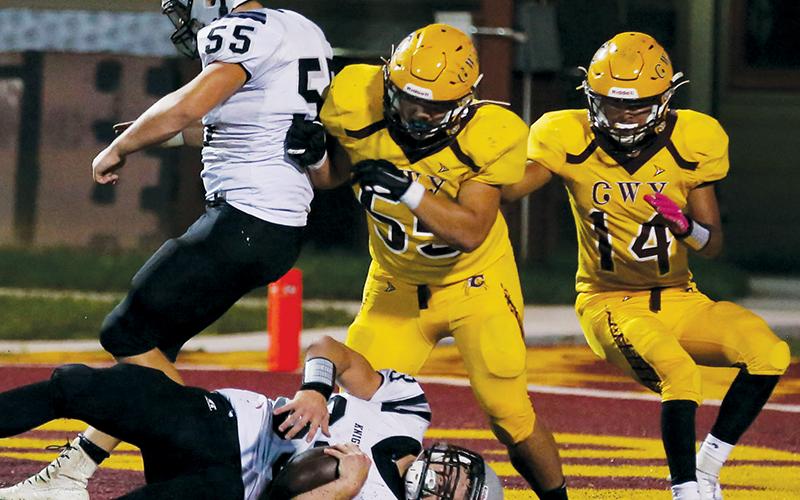 Koleson Dooley (55) keeps Cherokee’s Xavier Otter (55) at-bay long enough for fullback Kage Williams to cross the goal line Friday.