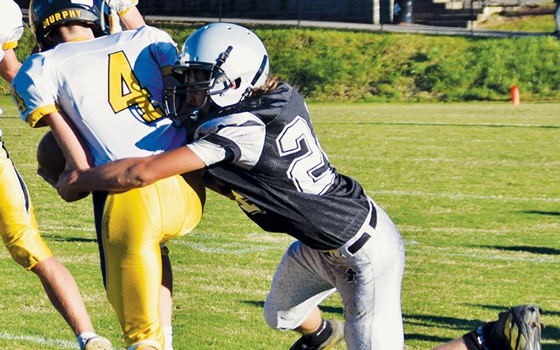 Andrew Adams wraps up Murphy’s Will Shore during Robbinsville’s loss to the Bulldogs on Sept. 23. Photo by Art Miller/amiller@grahamstar.com