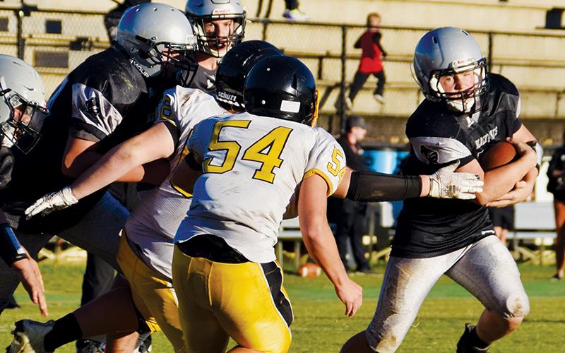 Junior varsity Black Knight Tanner Hedden (right) evades capture during the Sept. 23 home game against Murphy. Photo by Art Miller/amiller@grahamstar.com