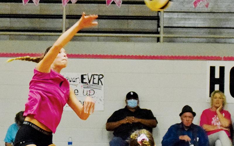With senior Kelsey Waldroup (2) looking on, Robbinsville sophomore Delaney Brooms fires a shot back to Cherokee during Tuesday’s Pink Game against the Lady Braves. Photo by Art Miller/amiller@grahamstar.com
