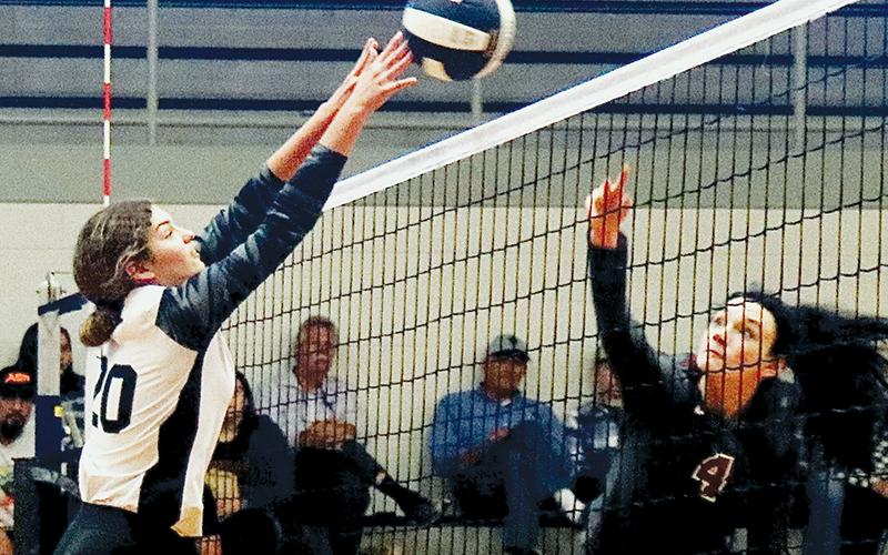 Lady Knights senior Yeika Jimenez (20) gets a fingertip on Addy Shaver’s return during Saturday’s first-round playoff match against South Stokes. Photo by Montana Buchanan/Robbinsville High School Yearbook