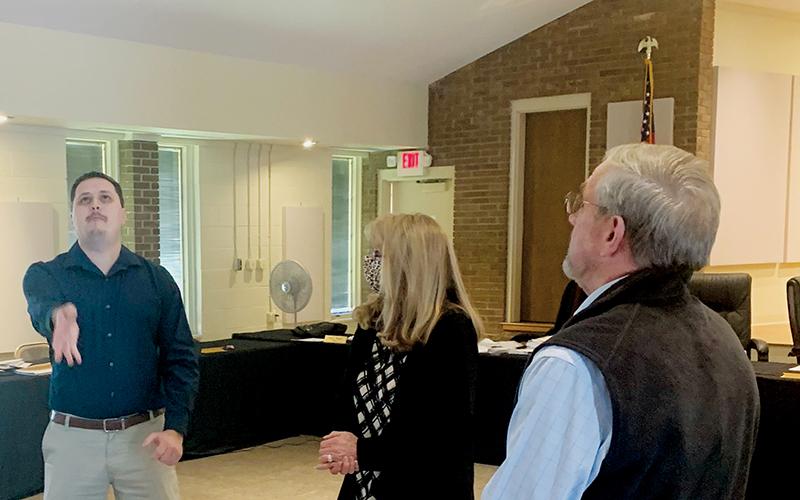 Graham Star publisher/editor Kevin Hensley (left) was selected to flip the coin that would break the tie for a seat on the Town of Lake Santeetlah council at Tuesday’s Graham County Board of Elections canvassing meeting. Observing the flip are election board chairman Juanita Colvard (center) and Town of Lake Santeetlah mayor Jim Hager. Photo courtesy of Beefy Rogers/Contributing Photographer