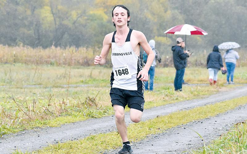 Robbinsville senior Hayden Stewart gutted out the rainy conditions at Saturday’s 1A Western Regional Meet in Bryson City to finish 11th, punching his ticket to the state race. Photo by Kevin Hensley/sports@grahamstar.com