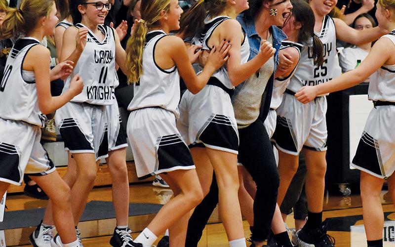 Members of the Robbinsville Middle School Lady Knights erupt with jubilation, moments after picking up a victory over Andrews in the closing seconds of their Nov. 4 home game. Photos by Kevin Hensley/sports@grahamstar.com