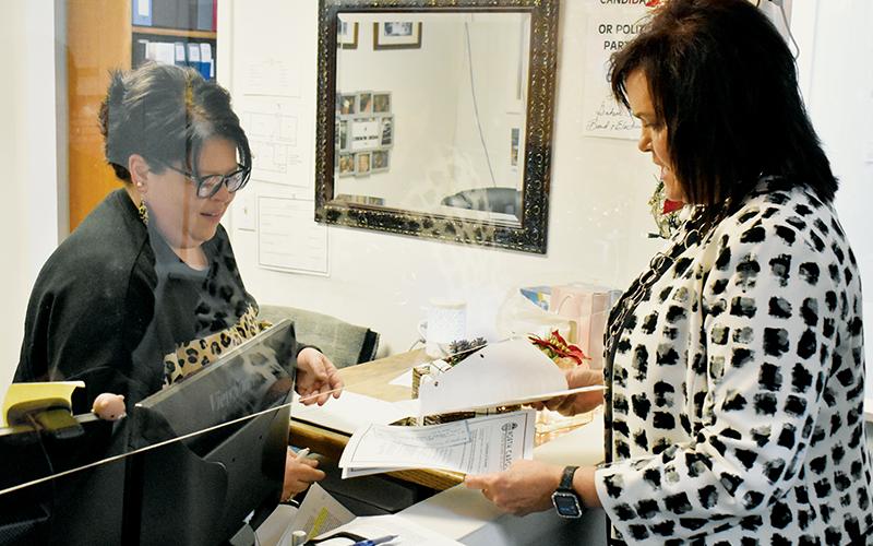 Graham County Board of Elections Deputy Director Tasha Holder (left) helps incumbent Graham County Clerk of Court Tammy Holloway with the filing process Monday. Holloway was the first candidate to file for any 2022 local election. Photo by Kevin Hensley/editor@grahamstar.com
