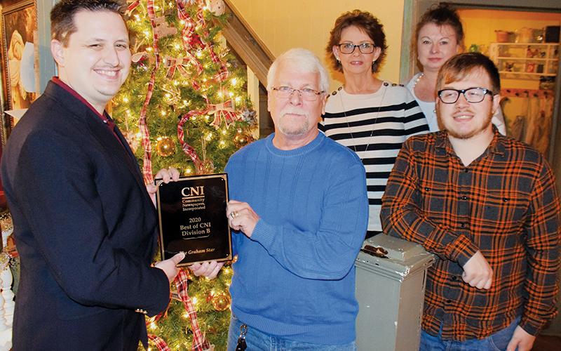 Graham Star personnel show off their “Best of CNI, Division B” award for 2020. Front row (from left) are Kevin Hensley, publisher/editor; Art Miller, staff photographer; and Charlie Benton, staff writer. Standing in back are Diane West, office manager (left) and Debbie Dills, advertising. Photo by Randy Foster/The Graham Star