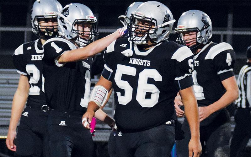 Carlos Wesley (56) receives some recognition from Zeke Silvers (1) during Robbinsville’s first-round playoff game against Winston-Salem Preparatory Academy on Nov. 5. Wesley was named the Smoky Mountain Conference Player of the Year. Photo by Art Miller/amiller@grahamstar.com