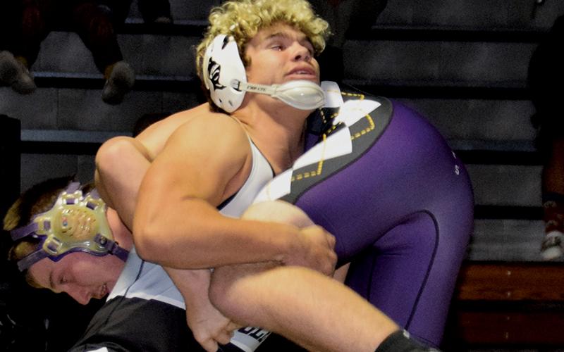 Sophomore Kage Williams (195) scoops Mitchell’s Noah Maltba during Nov. 17’s home dual. Photo by Art Miller/amiller@grahamstar.com