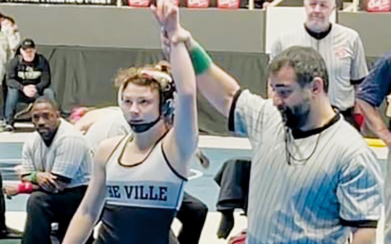 Robbinsville senior Aynsley Fink gets her hand raised Dec. 30, after winning the women’s 106-pound bracket at the annual Holy Angels showcase in Charlotte. Photo by Susan Crowe/Contributing Photographer