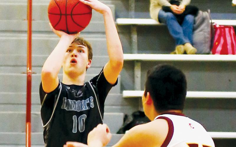 Black Knights freshman Bryce Adams lines up a corner shot Jan. 13 at Cherokee. Photo by Miranda Buchanan/Robbinsville High School Yearbook