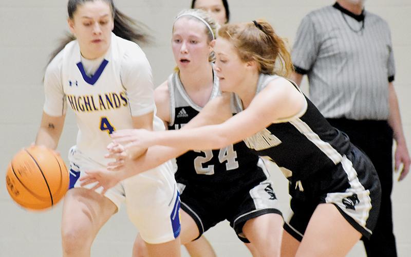 Robbinsville’s Kensley Phillips (24) and Halee Anderson apply heavy pressure to Highlands’ Julia Schmitt during Jan. 20’s road victory. Photo by Kevin Hensley/sports@grahamstar.com