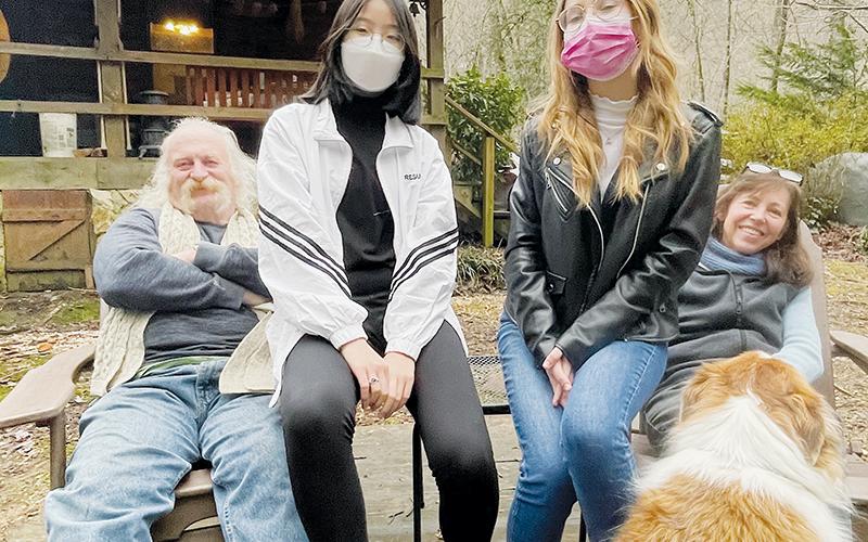 From left, host Rob Mason, exchange students Seoyun Choi and Giorgia Magnani, and host Robin Mason gather for a picture beside West Buffalo Creek. The dog’s name is Tucker. Photos by Randy Foster/news@grahamstar.com