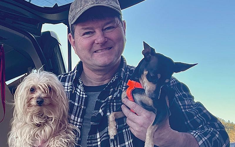 Graham Star courier Neal Wachob, with his two canine companions: Tater (left) and Puppy. Photo by Randy Foster/news@grahamstar.com