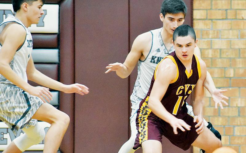 Robbinsville’s Bo Rattler (left) and Dasan Gross guard Cherokee’s Tso Smith during Saturday’s Smoky Mountain Conference Tournament quarterfinal game against the Braves. Photo by Kevin Hensley/sports@grahamstar.com